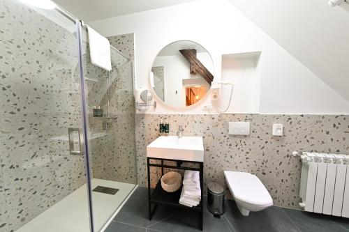 a bathroom with a sink and a shower at Leda Residence in Oradea