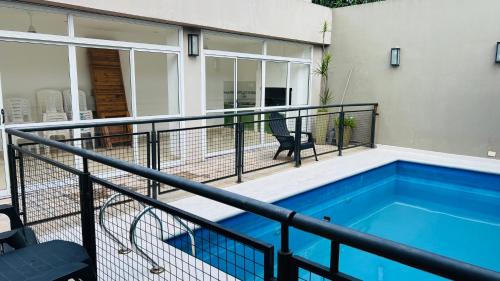 a balcony with a swimming pool next to a house at Bernabe Boulevard in San Miguel de Tucumán