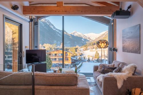 a living room with a view of a mountain at Chalet Seven Summits - Pool - Sauna - Jacuzzi in Chamonix-Mont-Blanc