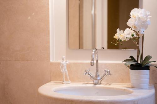 a bathroom sink with a faucet and a mirror at Alla Vigna - Room Only in Venice