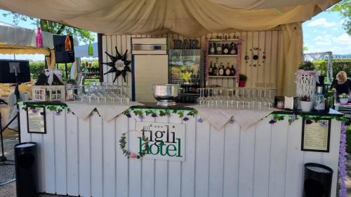 a bar in a tent with a counter with drinks at HOTEL AI TIGLI in Langhirano