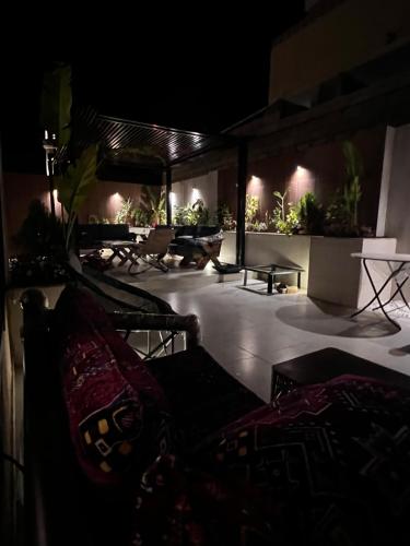 a patio with chairs and tables at night at أجنحه الفرسان الفاخره in AlUla