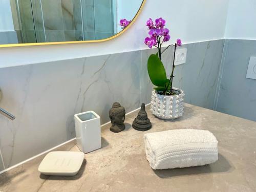 a bathroom counter with a towel and a mirror at Poetto Beach House - Molara1 in Cagliari