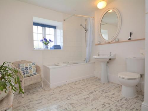a bathroom with a tub and a toilet and a sink at 1 Bed in Bude 43697 in Morwenstow