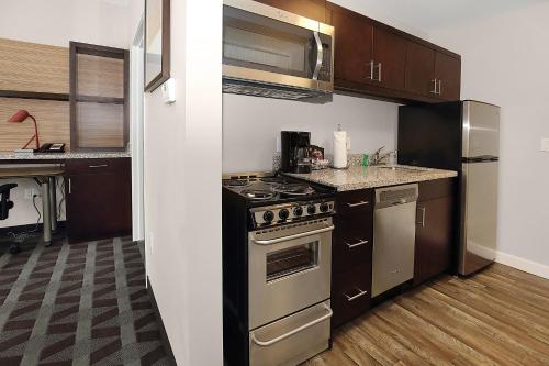 a kitchen with a stove and a counter top at TownePlace Suites by Marriott Grove City Mercer/Outlets in Grove City