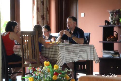 a group of people sitting at a table at Airport Villa in Katunayake