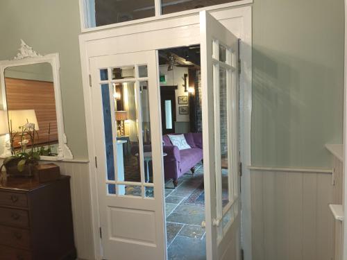 a room with a door leading to a bedroom at Baskerville House in Clyro
