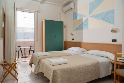 Postel nebo postele na pokoji v ubytování Hotel Leon D'oro