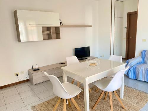 a white dining room with a white table and chairs at Residenza Camilla in Vicenza