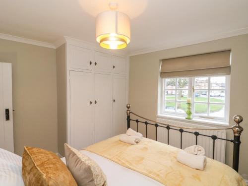 a bedroom with a bed and a window at Kestrel Cottage in Middlesbrough