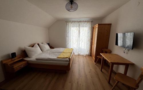a small bedroom with a bed and a window at Ferienhaus Valentina in Grundlsee
