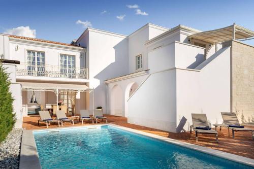a villa with a swimming pool and a house at Luxury Villa Constanza near Poreč for 8 people only 2 km from the sea in Vabriga
