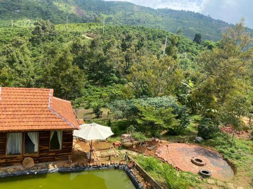 an overhead view of a house with an umbrella at Lam Nguyên Charming House in Bao Loc