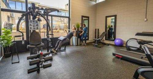 a gym with people standing in a room with machines at Old Orchard Inn in Wolfville