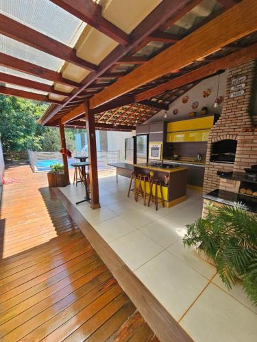 an open deck with a fireplace and a dining area at Casa no pé da Serra da Cantareira in São Paulo