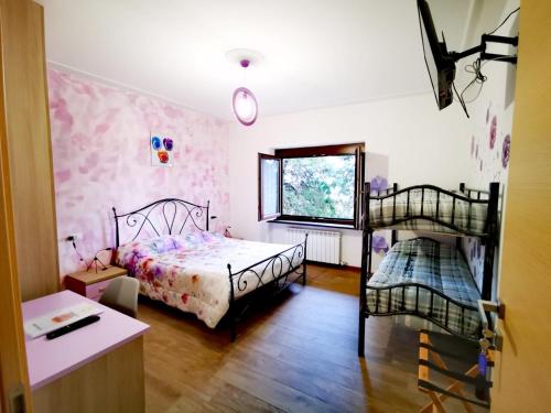 a bedroom with two bunk beds and a window at B & B La Mela in Darfo