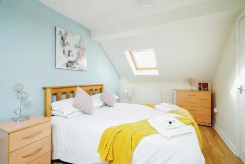 a bedroom with a white bed and a dresser at Temple Apartment by Beds Away in Oxford