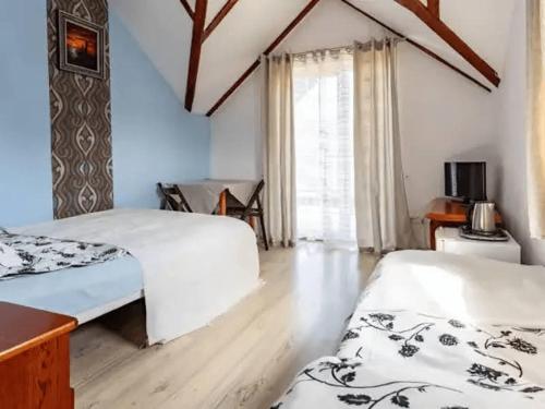 a room with two beds and a window at B&B Artemida in Ostrowo
