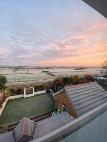 a view of a field from the roof of a house at Aintree Grand National Home in Aintree
