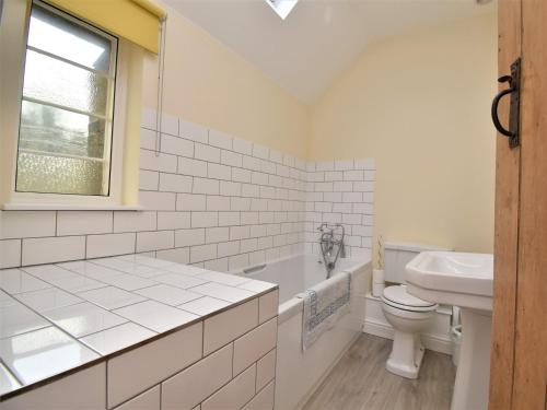 a white bathroom with a toilet and a sink at 1 Bed in Ironbridge 80411 in Ironbridge
