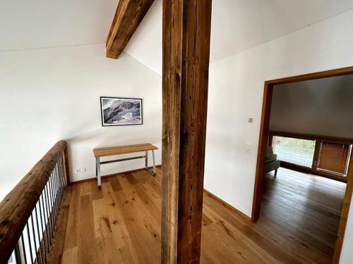 a hallway with a table and a mirror in a house at Stylish chalet w/Sauna: Alpine escape in Tinzen