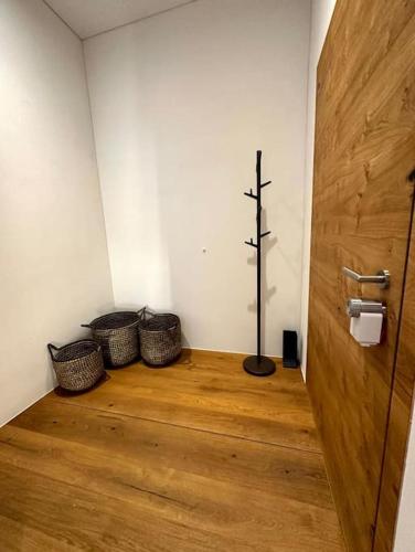 a room with three baskets and a wooden door at Stylish chalet w/Sauna: Alpine escape in Tinzen