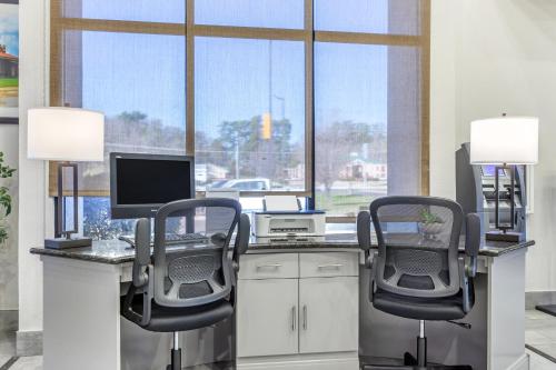 an office with two chairs and a desk with a computer at Comfort Suites Nacogdoches in Nacogdoches