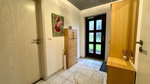 a hallway with a refrigerator and a door with a window at Ferienwohnung Panoramablick in Erbach im Odenwald