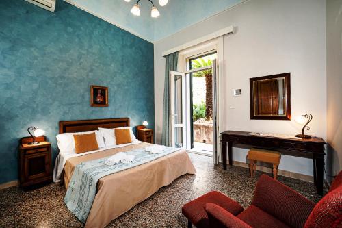 a bedroom with a bed and a desk in a room at Villa degli Ulivi in Taormina