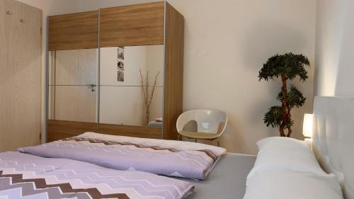 a bedroom with a bed and a mirror at Ferienwohnung Panoramablick in Erbach im Odenwald