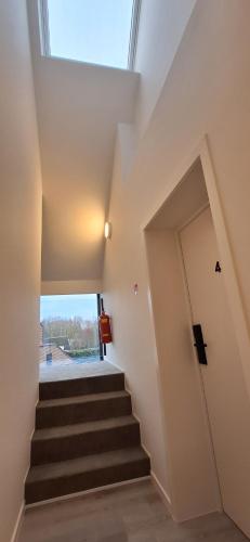 a staircase in a house with a skylight at Den Ommegang in Halle