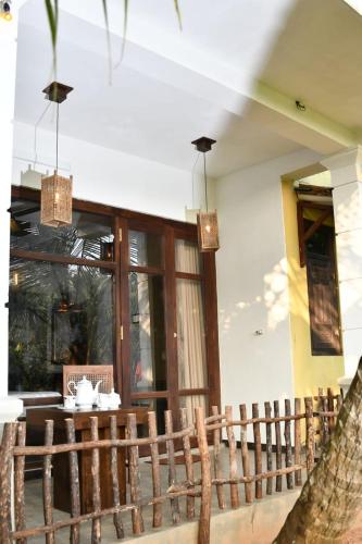 a wooden fence in front of a house at Guruwaththa Eco Lodge in Hikkaduwa