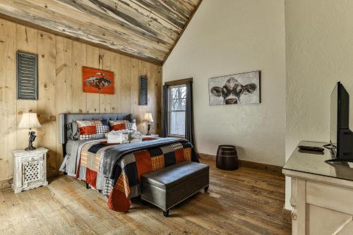 a bedroom with a bed and a television in it at French Kisses in Ellijay