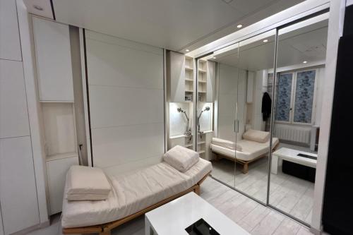 a living room with a couch and a mirror at Bright apartment in the heart of Paris in Paris