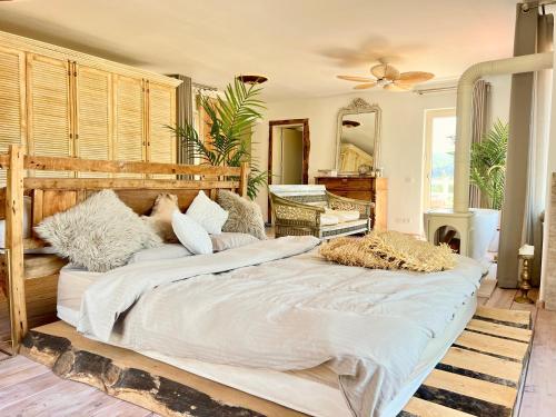 a large bed with white sheets and pillows in a room at Villa Storm - Very Stylish Villa w/Pool & Garden in Gocek Hills in Fethiye