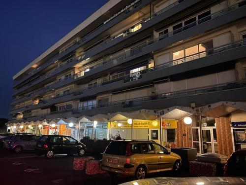 a parking lot with cars parked in front of a building at Luxueux Appartement Jacuzzi proche de Paris in La Celle-Saint-Cloud