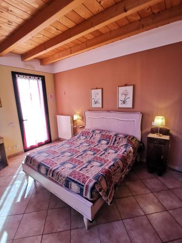 a bedroom with a large bed in a room at Agriturismo Dondino in Cavriana