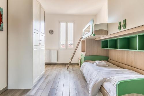 a bedroom with a bed in a room with green shelves at Milano NABA Flat Full Wi-Fi New- Via Meda in Milan