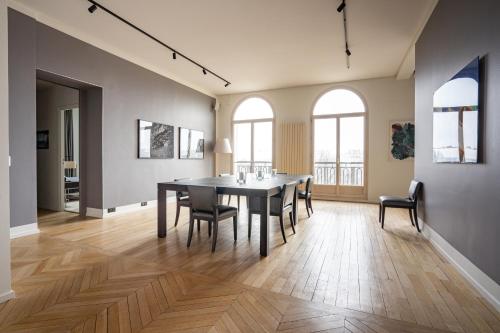 a dining room with a table and chairs at Luxury 4 Bedroom Eiffel Tower View in Paris