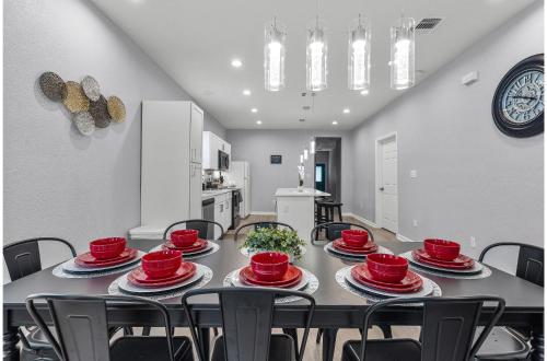 a dining room with a table with red dishes on it at Charming Walkable 4 BR2.5 BA Near Dtown Riverwalk in San Antonio
