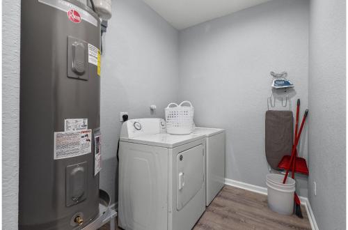 a small kitchen with a refrigerator and a small cabinet at Charming Walkable 4 BR2.5 BA Near Dtown Riverwalk in San Antonio