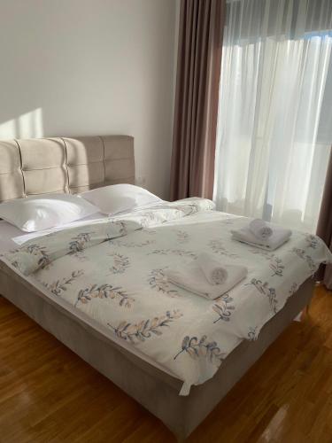 a bed with two towels on it in front of a window at Vista in Trebinje