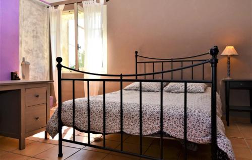 a bedroom with a black bed and a window at MAS DES MAGNARELLES / UZES / CEVENNES in Méjannes-lès-Alès
