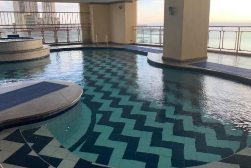 a swimming pool on the top of a building at Alpha Grandview Malate Condo 2005 in Manila