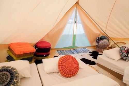 a room with a tent with pillows and a window at Maria Deck Urban Glamping in Manila