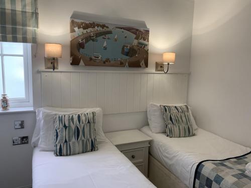 a small room with two beds and two lamps at Blue Anchor Retreat at The Bay Filey, sleeps 4, 2 dogs welcome for free too in Filey