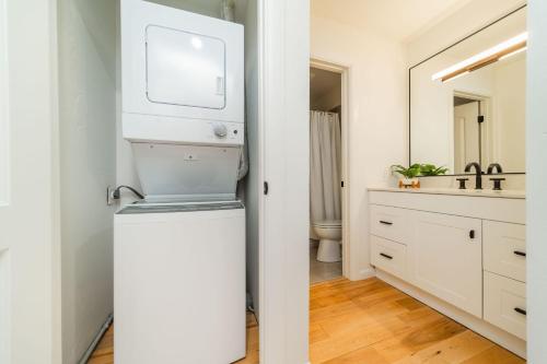 a bathroom with a sink and a washer and dryer at New Listing Just renovated 3BR 3BA in Snowmass Village