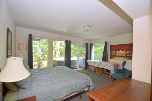 a bedroom with a bed and a desk and a table at Serendipity -- Hot Tub - Pet Friendly - Fire Pit - Grill - Porch - Deck - Wifi - Pool Access - Games in Berkeley Springs