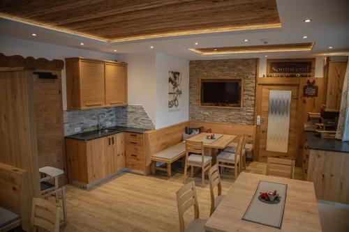a kitchen and dining room with a table and chairs at Pension-Appartement Sonnwend in Westendorf