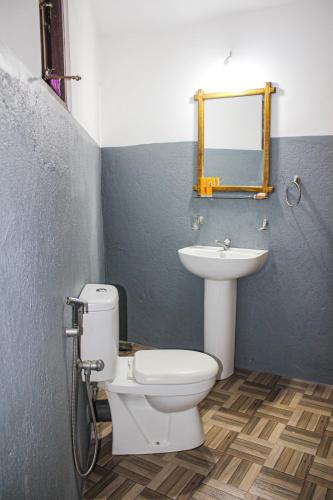 a bathroom with a toilet and a sink at Seasons Four Mini Jungle Cabana in Matara
